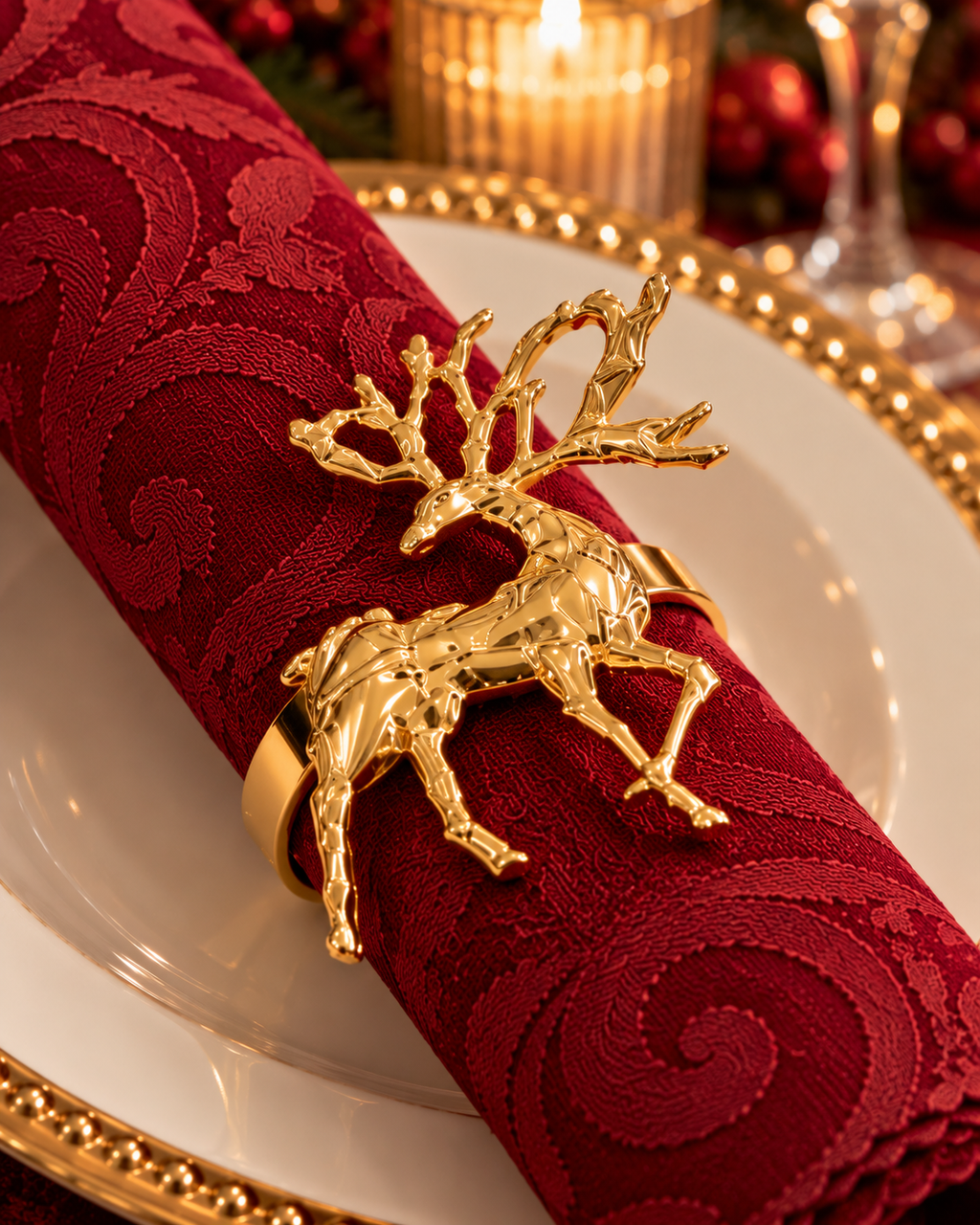 Gold reindeer napkin ring on a burgundy jacquard napkin, by NYOUME